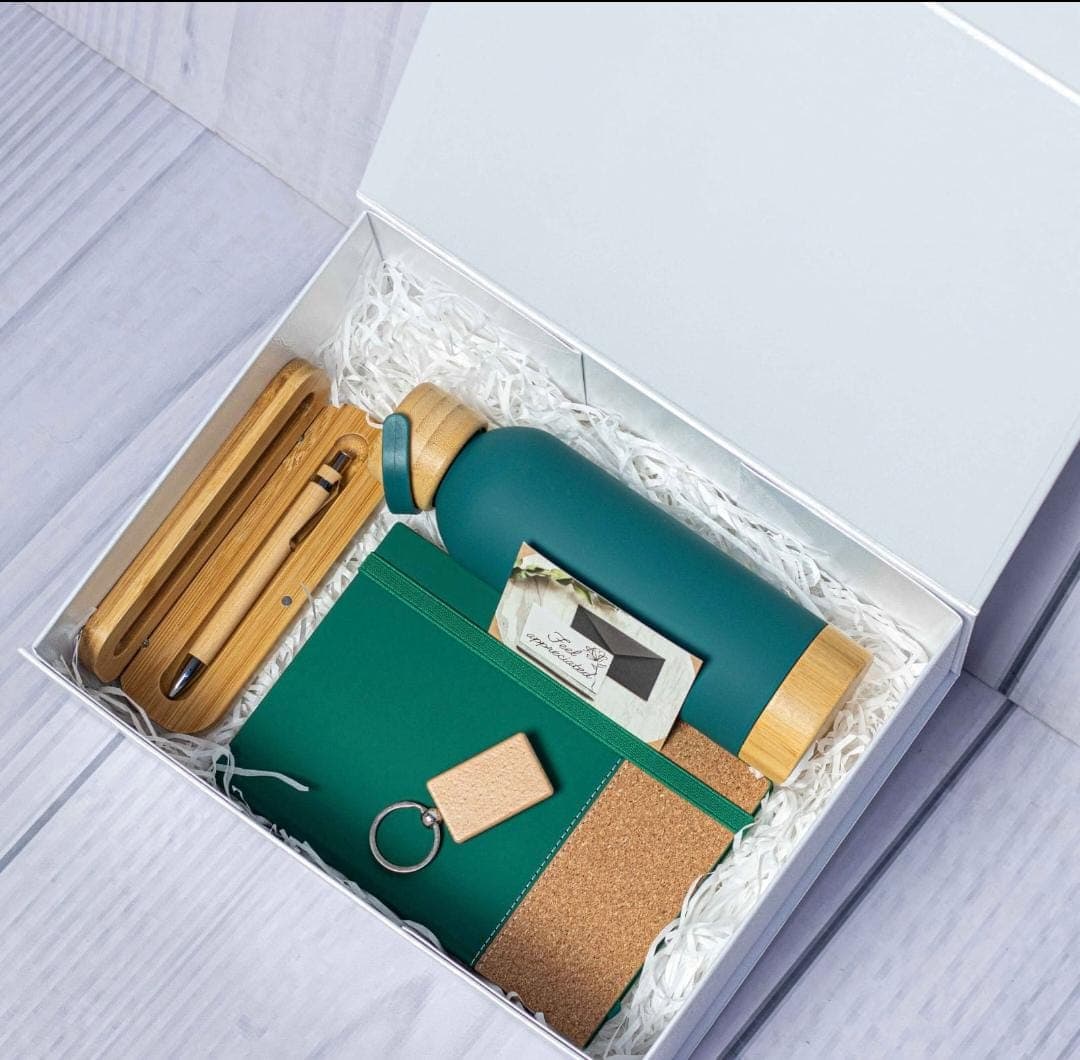 A premium executive gift kit with a bottle, notebook and accessories.