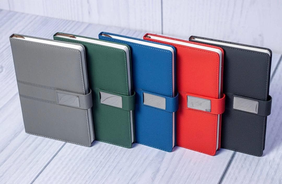 A coordinated collection of professional notebooks in multiple brand colors.